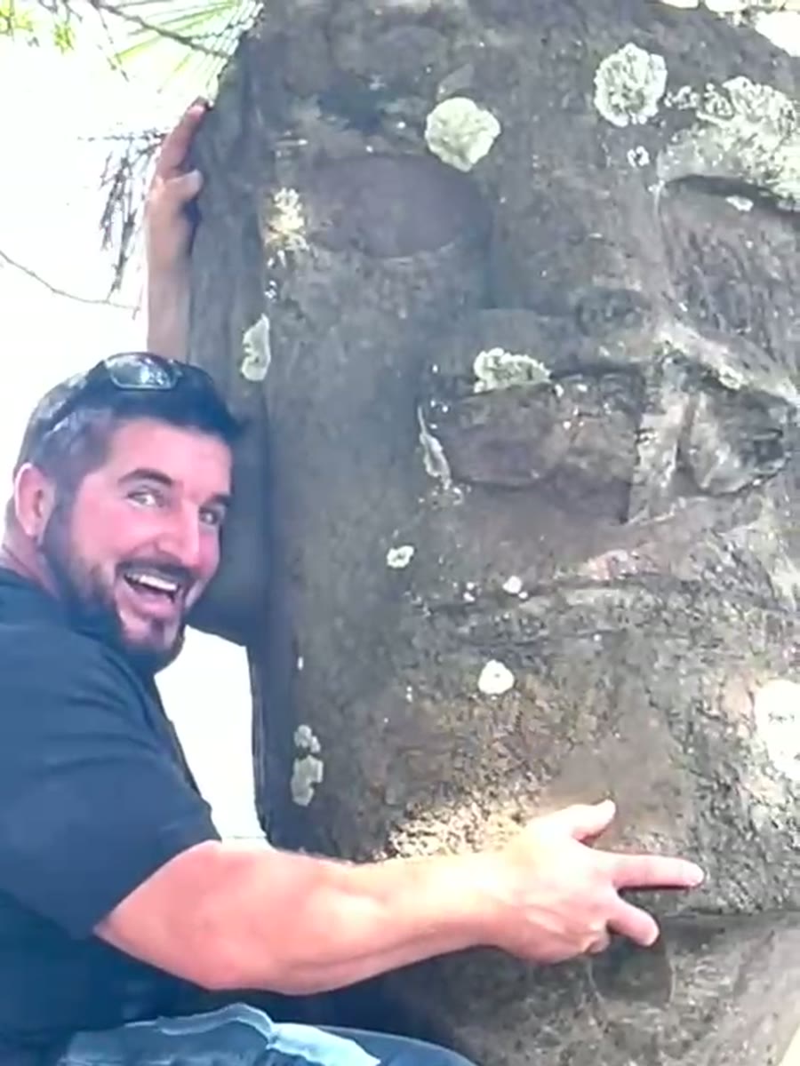 Barry Billcliff travel video still beside a moai statue on Easter Island, Chile
