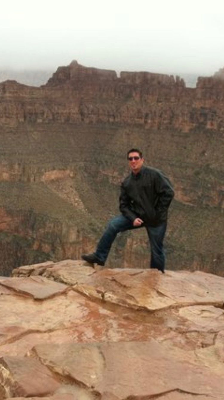 Barry Billcliff standing at a canyon rim overlook during an outdoor adventure